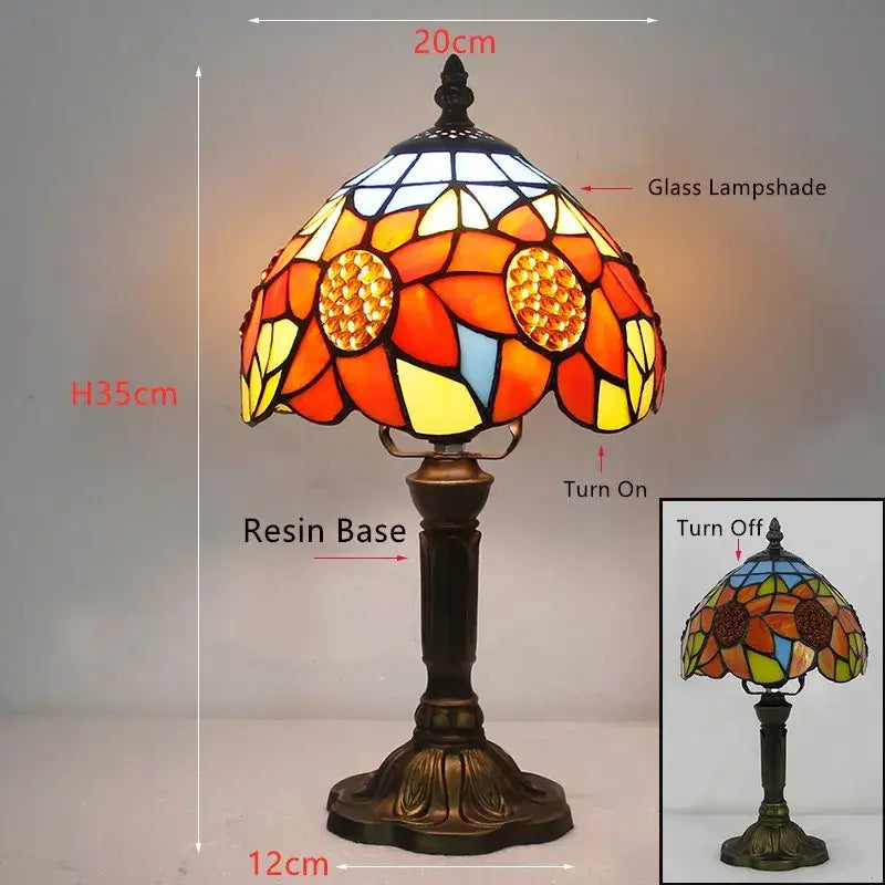 A vibrant orange and yellow stained glass e27 retro baroque led table lamp with resin base and intricate floral patterns