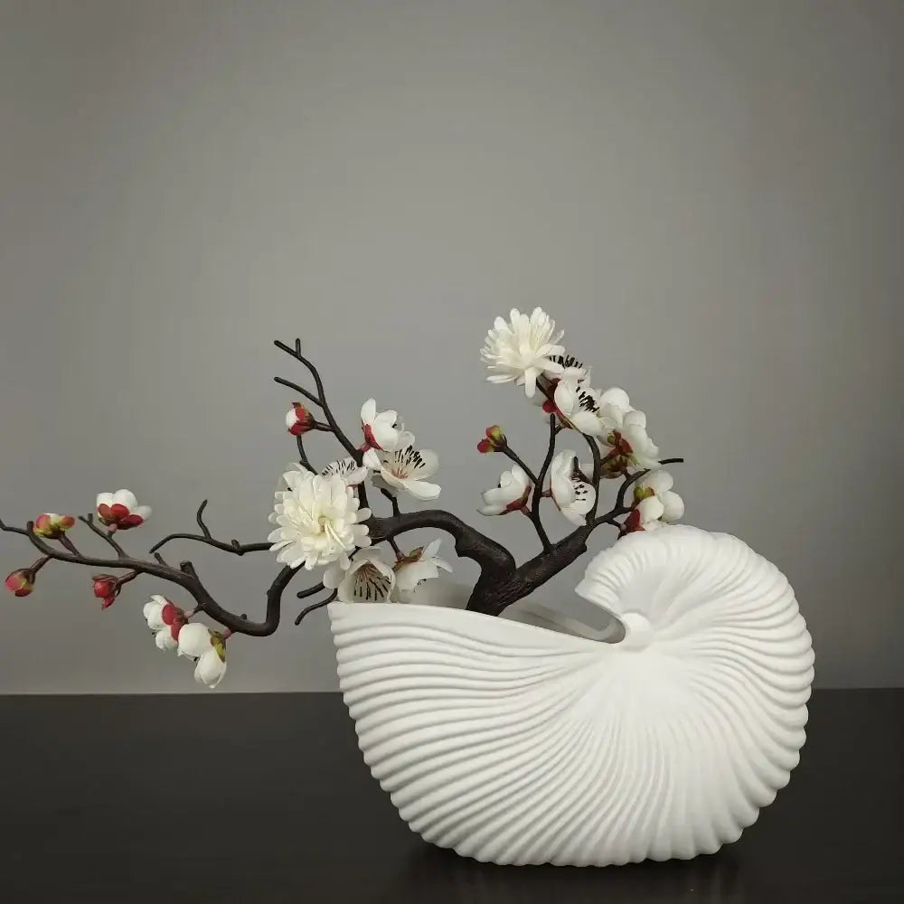 DecorBites™ elegant ceramic vase in white shell conch design holding dark brown branches with white and pink blossoms