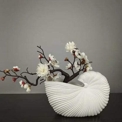 DecorBites™ elegant ceramic vase in white shell conch design holding dark brown branches with white and pink blossoms