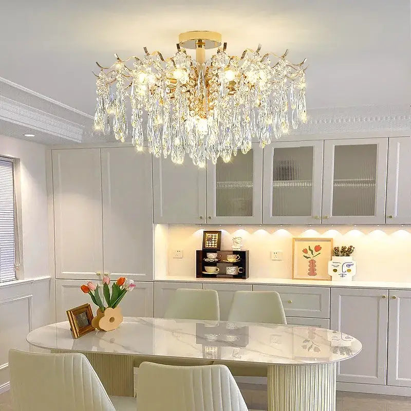 A decorbites elegant crystal chandelier with gold branching arms and cascading crystal droplets for dining rooms