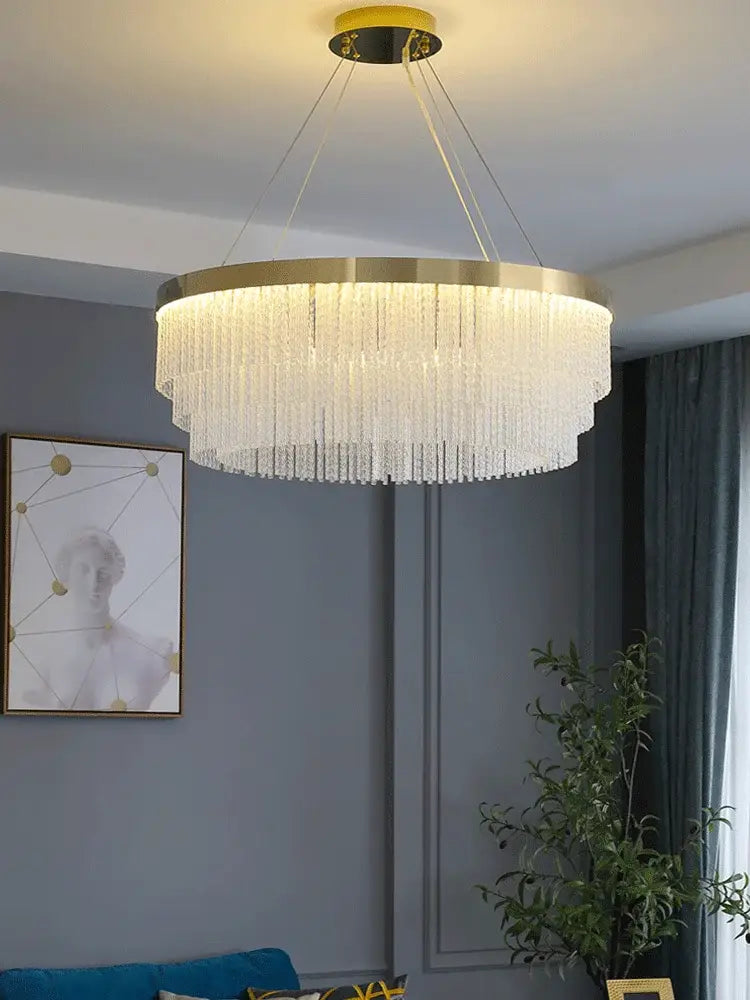 DecorBites™ elegant gold crystal chandelier featuring a modern gold luster metal frame with cascading clear crystals