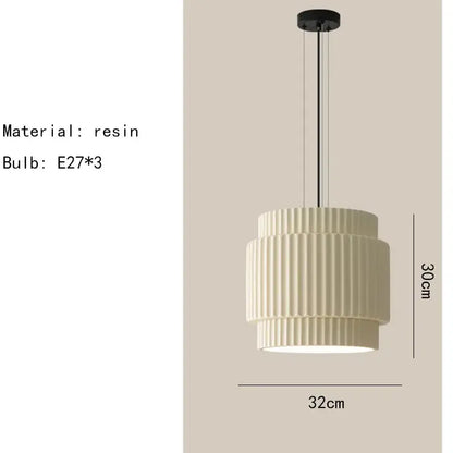 Cream-colored tiered fluted resin pendant light with black metal hardware by Decorbites elegant resin for dining room
