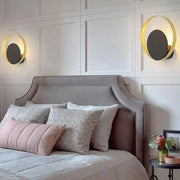 Decorbites™ ellen modern wall sconces feature gold-rimmed circular design with dark gray centers on white paneled walls