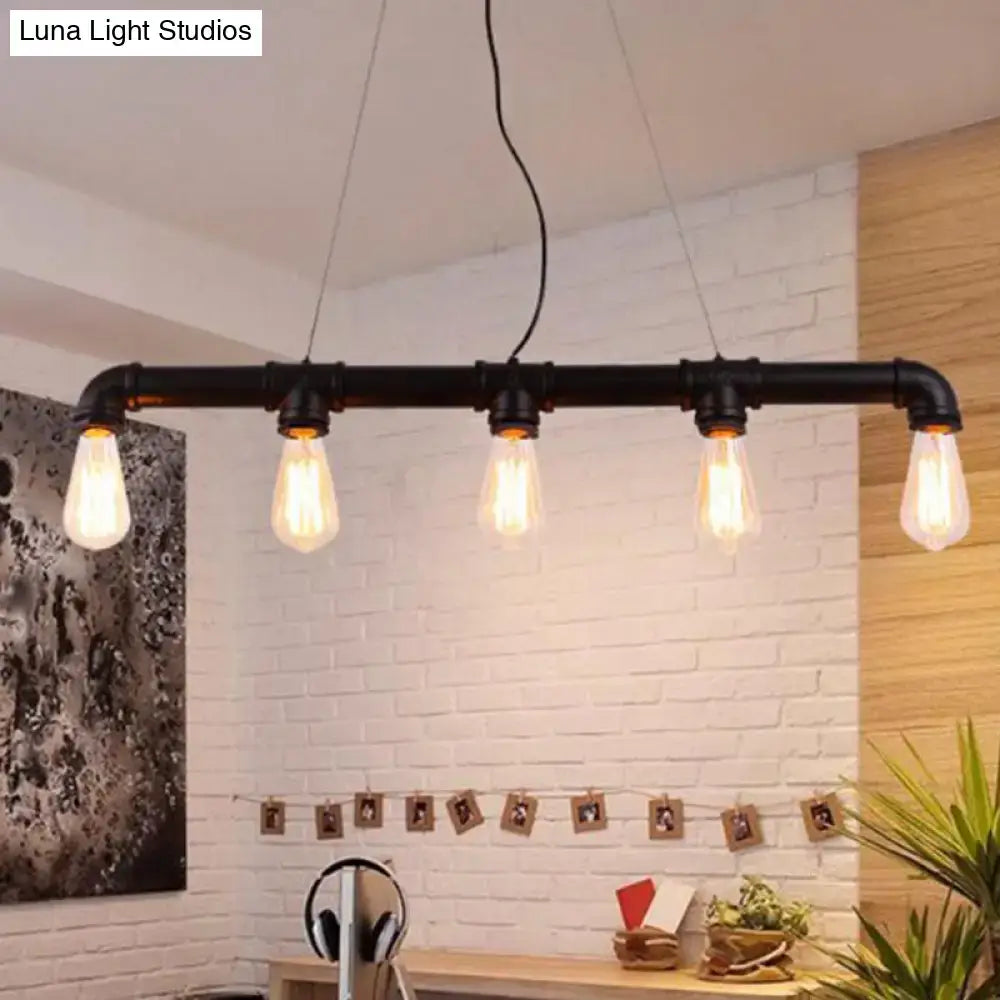 Black industrial-style elongated pipe island pendant light with five exposed edison bulbs for dining room decor