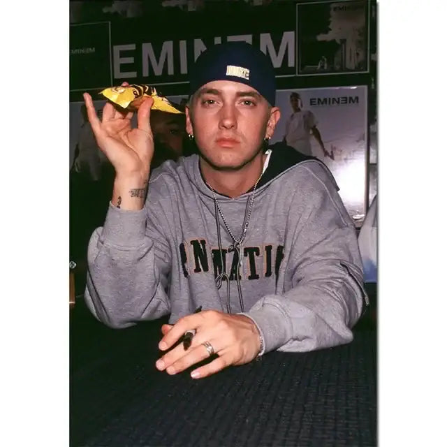 DecorBites Eminem posters and prints featuring music star wall art with Eminem in gray hoodie and dark blue cap