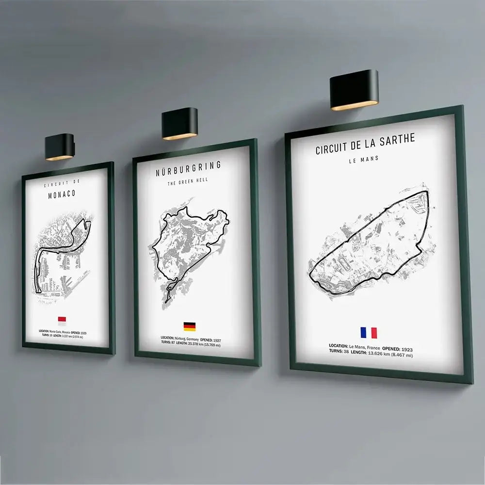 Three framed black and white f1 circuit canvas paintings with dark green frames labeled in bold uppercase wall art
