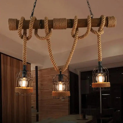 Rustic wooden beam chandelier with thick beige rope and three brown iron bird cage pendant light fixtures