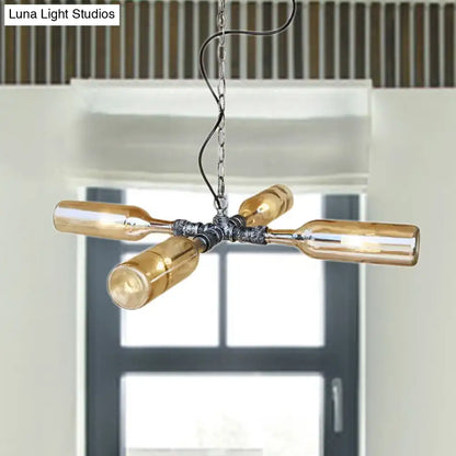 Industrial chandelier with four amber glass bottles in aged silver black metal and smoke gray blue finish hanging lamp