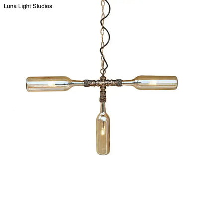 A rustic farmhouse style pendant light with three amber glass bottles in aged silver black and smoke gray blue finish
