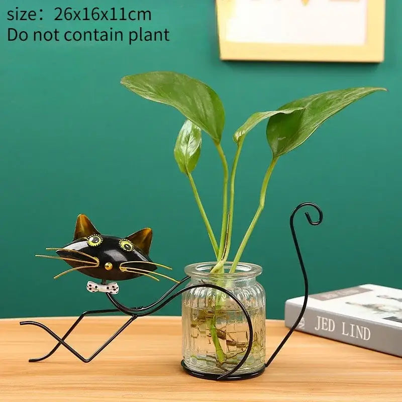 Decorbites™ flamingo metal vase black metal cat-shaped plant stand with gold accents holding green leaves in glass jar