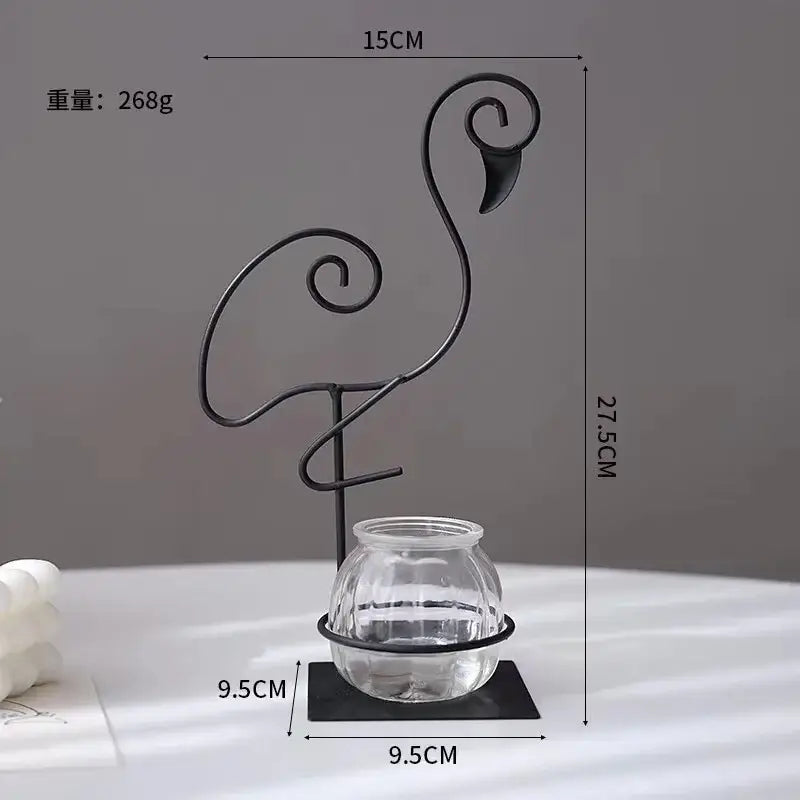 Black wrought iron flamingo metal vase with clear glass jar base for elegant home decor by DecorBites