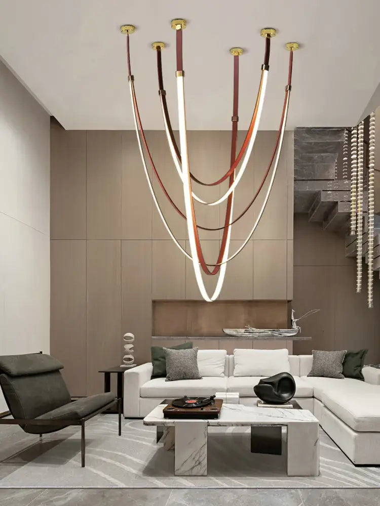 DecorBites™ flex leather belt led chandelier light with curved white and brown leather strips suspended from gold fixtures