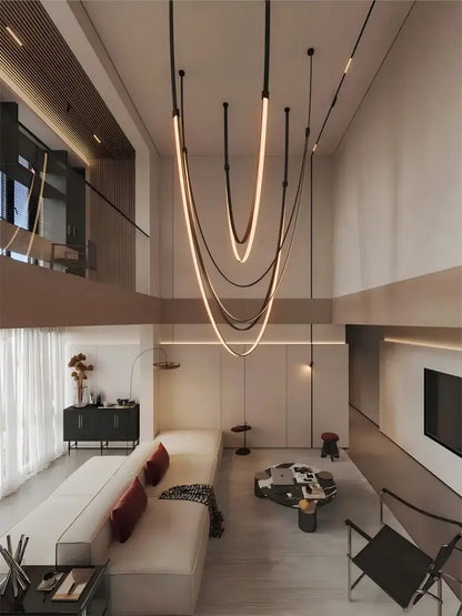 Modern minimalist DecorBites™ flexible leather belt LED chandelier with sleek curved light strips in warm glow for living room