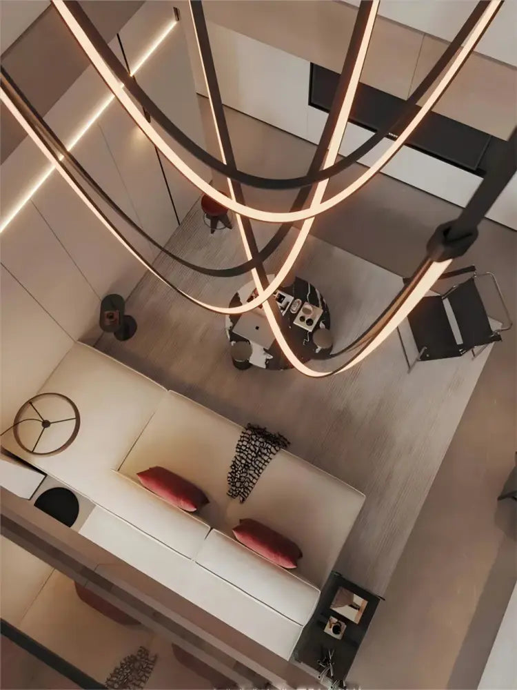 Modern minimalist DecorBites™ flexible leather belt LED chandelier with sleek curved metallic arms and warm ambient lighting