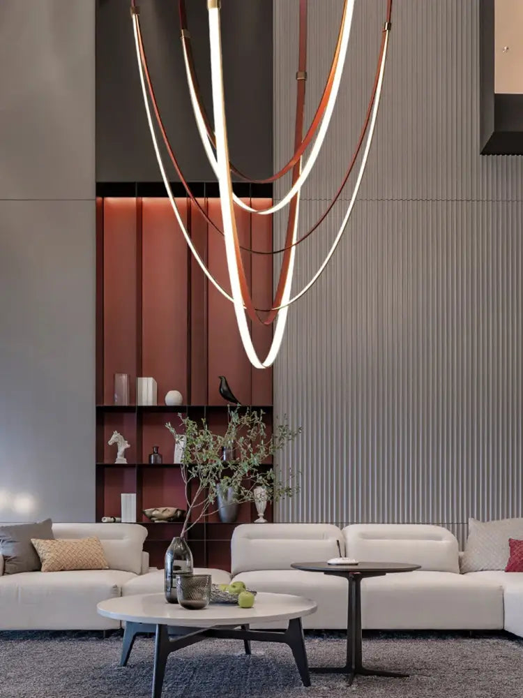 Modern sculptural chandelier with intertwined copper and white led strips featuring decorbites flexible leather belt design