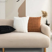 Cream-colored sofa with gold-tone legs featuring decorbites fluffy faux fur cushion cover in cream and brown tones