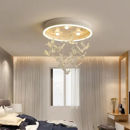 A modern white frame decorbites flying bird ceiling light with hanging crystal bird ornaments for bedroom use