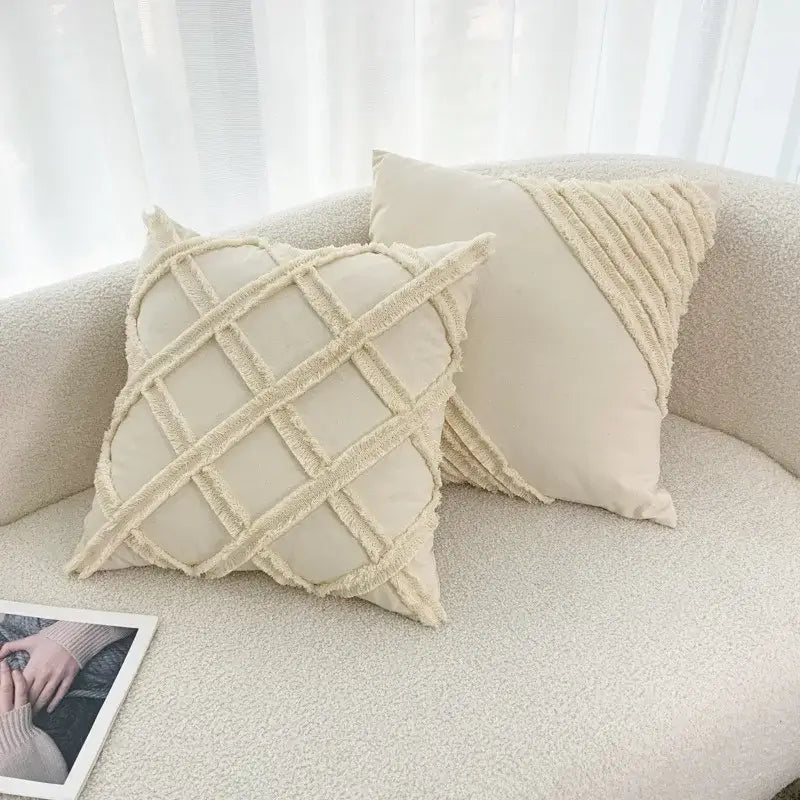 Cream-colored throw pillows with decorbites fringed geometry textured frayed grid and diagonal fabric accents for living room