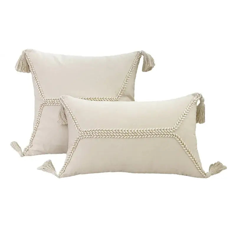 Cream-colored rectangular throw pillows with braided rope trim and tassels from decorbites fringed geometry cushion cover