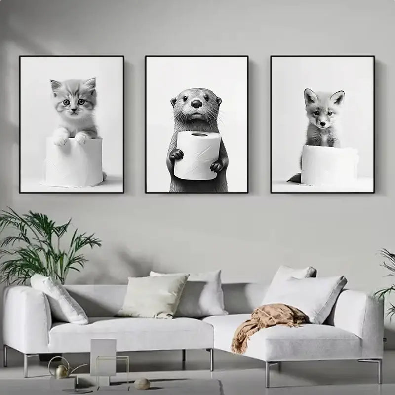 Set of three black-and-white framed funny animals wall art prints featuring a kitten otter and fox with toilet paper for bathroom home