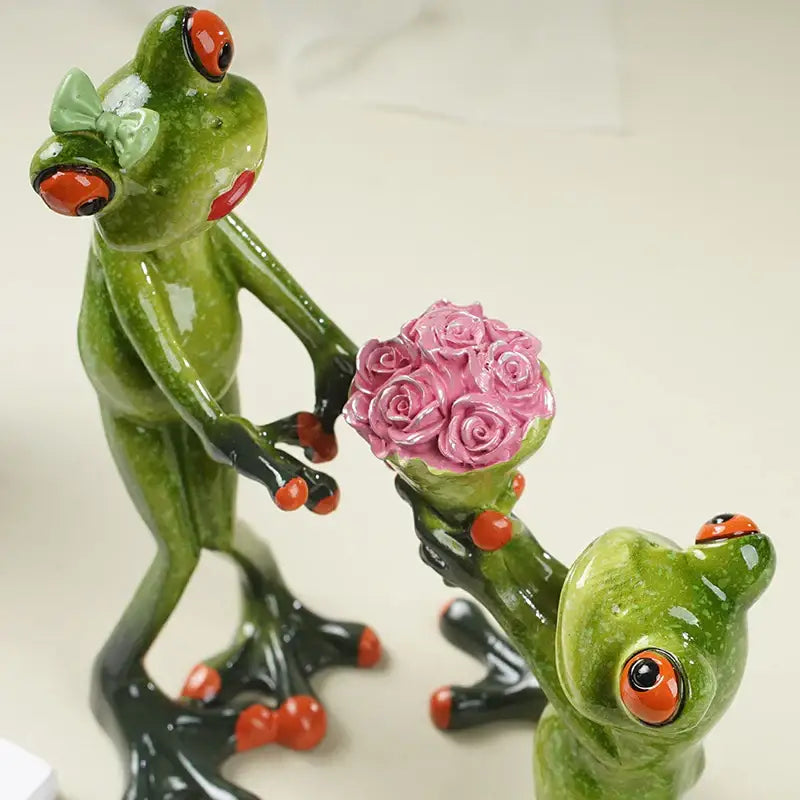 Green ceramic frog figurine with orange eyes and red lips holding pink roses from decorbites funny frog couple resin decor