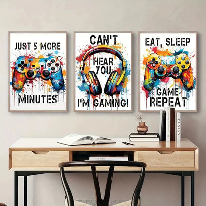 Three framed DecorBites™ graffiti gamepad posters with vibrant splattered paint for stylish gamer room decor