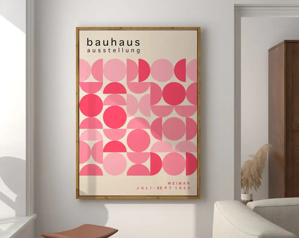 A framed geometric bauhaus canvas art featuring overlapping pink circles on off-white background for mid century decor