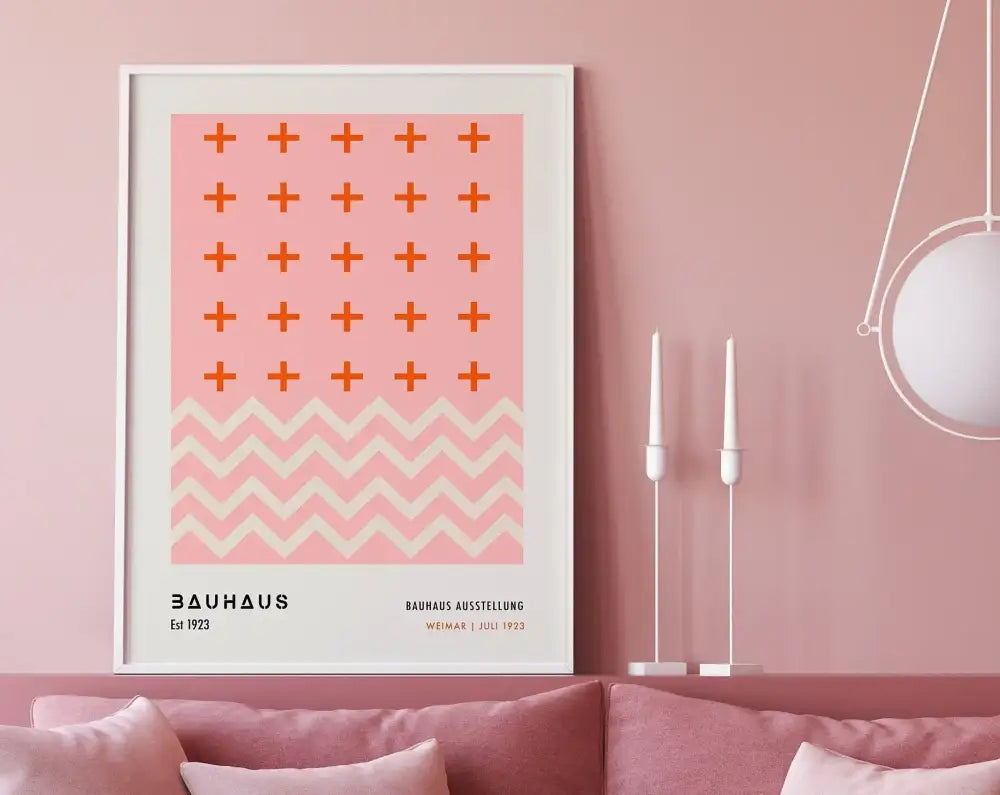 A framed decorbites™ geometric bauhaus canvas poster with pink background, orange plus signs, and white zigzag pattern
