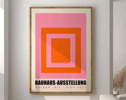 A framed decorbites™ geometric bauhaus canvas poster with concentric pink and orange squares and black text on cream mat