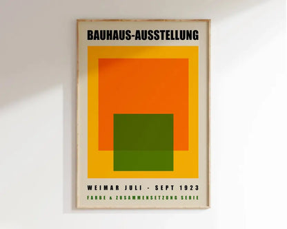 A framed geometric bauhaus canvas poster with bold orange green and yellow shapes on a cream background by decorbites