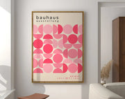 A framed decorbites geometric bauhaus canvas poster featuring overlapping pink circles and bauhaus ausstellung text