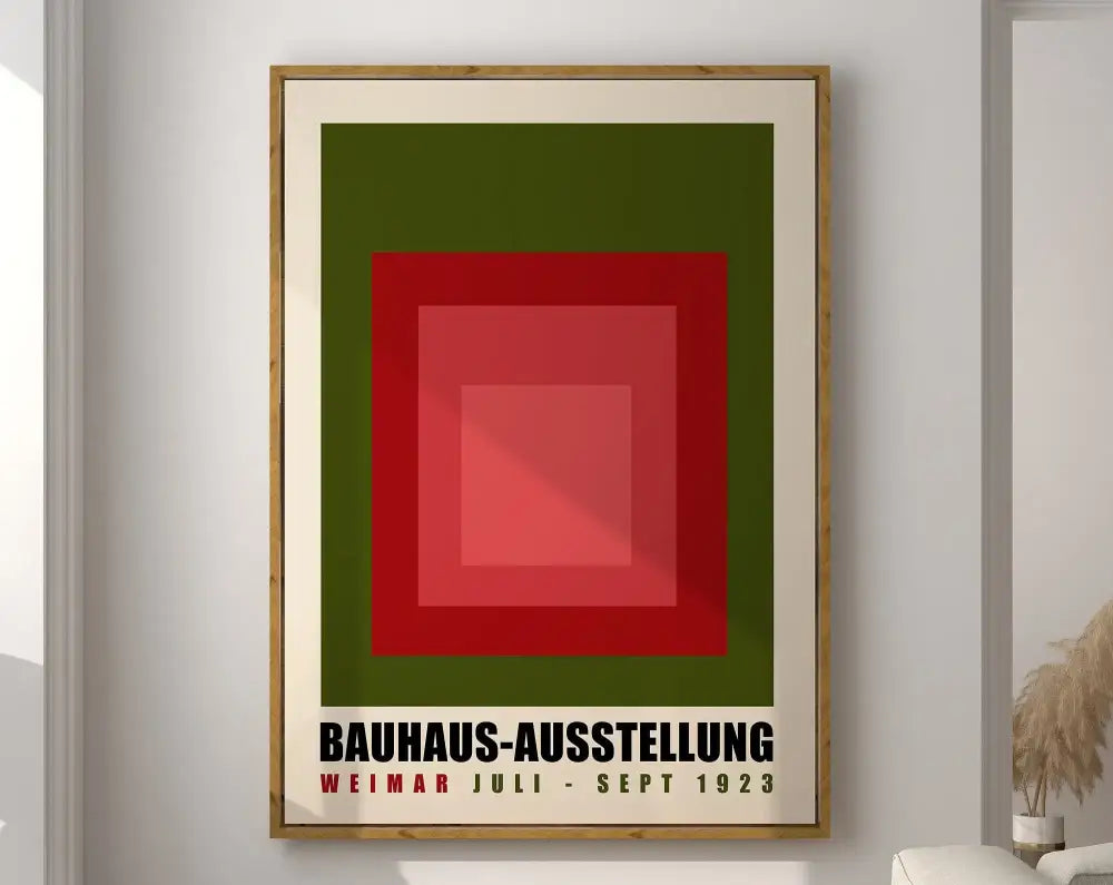 Framed geometric bauhaus canvas print with concentric red and green squares and black text on cream mat for modernist decor