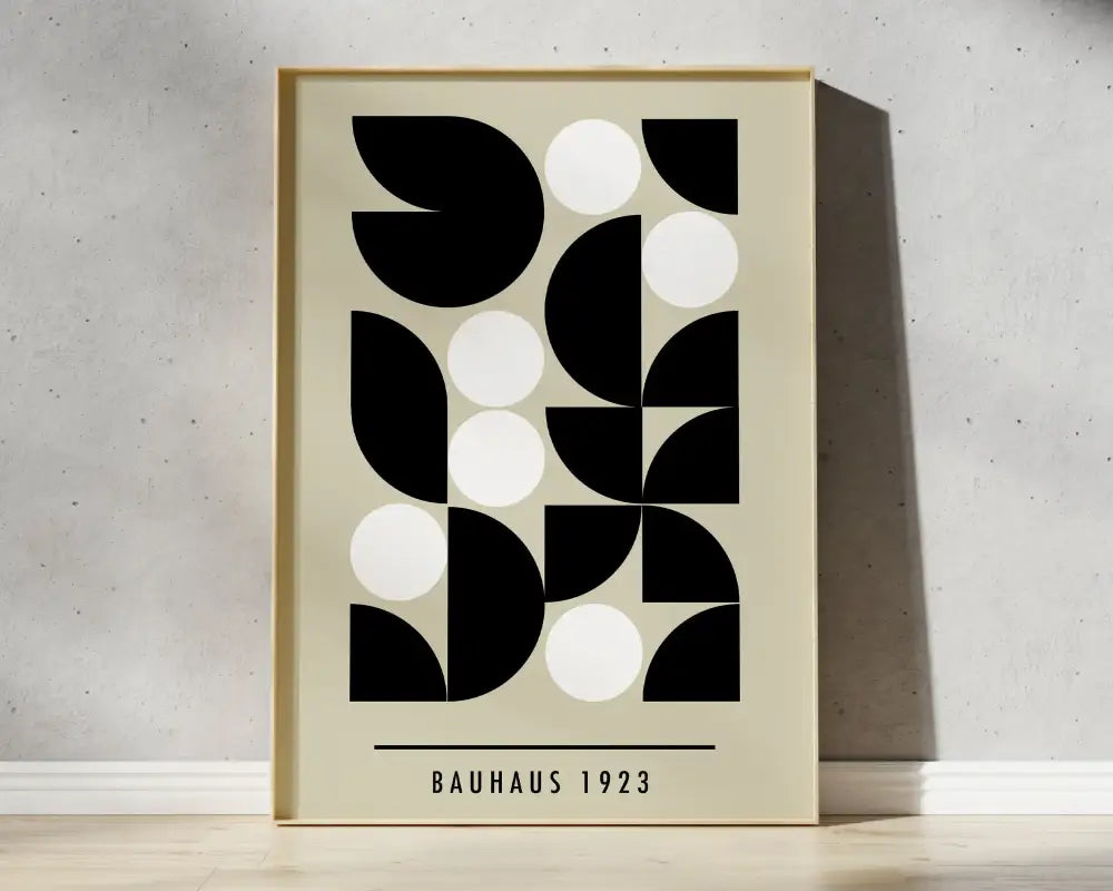 Minimalist bauhaus 1923 geometric bauhaus canvas print in light wood frame with black and white shapes on off-white wall art