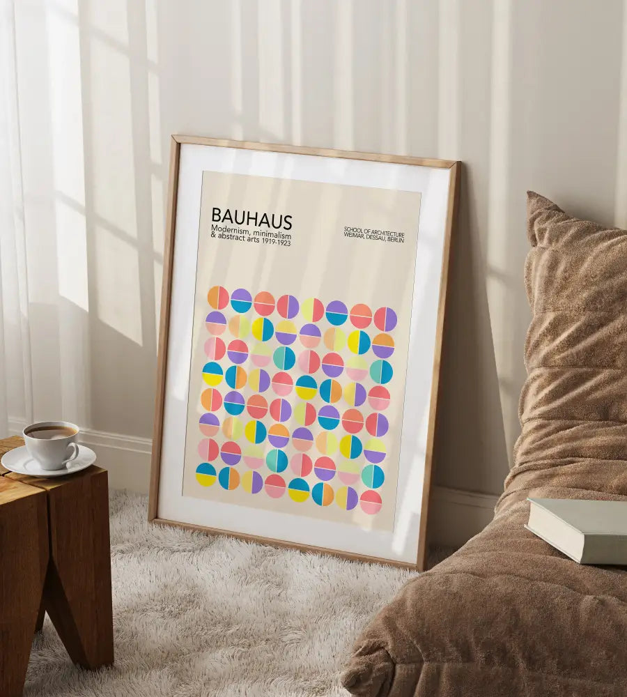 A framed decorbites™ geometric bauhaus canvas print with pastel half-circle patterns on beige wall art in light wood frame