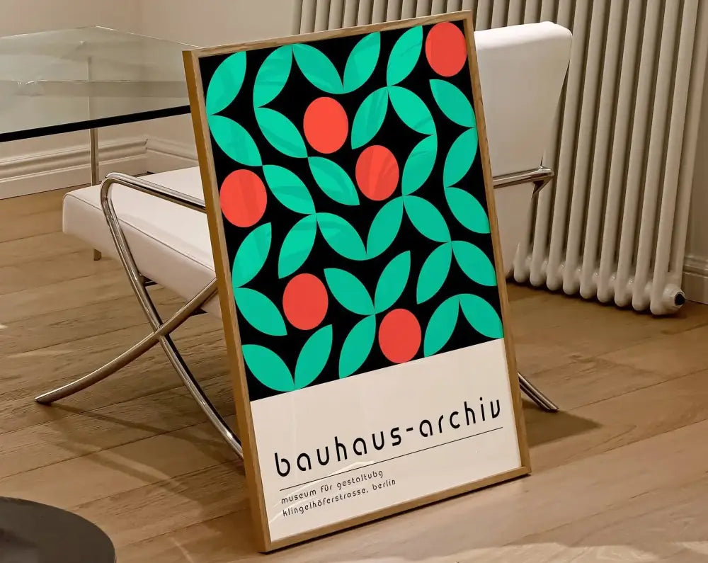 A framed decorbites™ geometric bauhaus canvas print with teal leaves red circles on black featuring bauhaus-archiv text