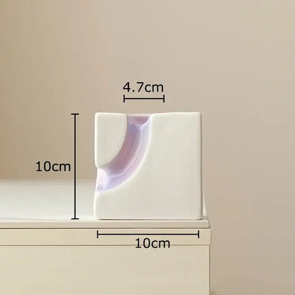 Minimalist white ceramic Decorbites geometric blocks vase with curved indentation and lavender interior for living room decor