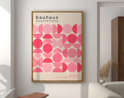 A framed decorbites™ geometric canvas poster with overlapping pink circles and bauhaus exhibition text from 1923