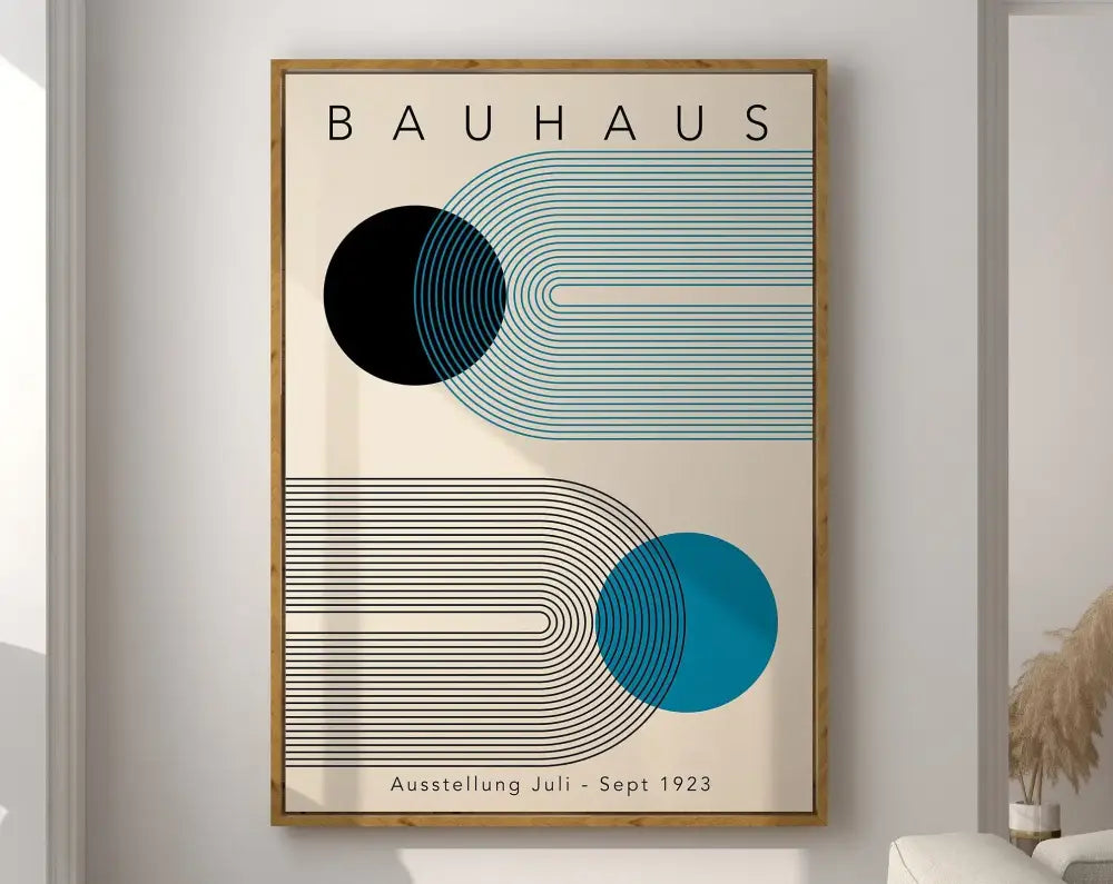 A framed decorbites™ geometric canvas poster with bold black and teal shapes on cream in a light wood frame