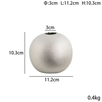 A sleek matte silver spherical ceramic vase with subtle texture and small opening from decorbites geometric gold collection