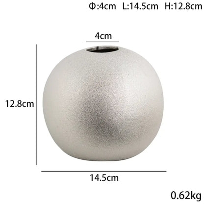 A sleek matte silver ceramic vase with a rounded tapered shape from decorbites geometric gold spherical vases collection