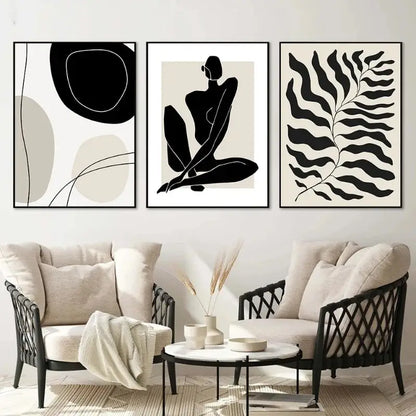 Three minimalist black and white framed boho canvas art prints featuring geometric leaf rainbow designs above a sofa