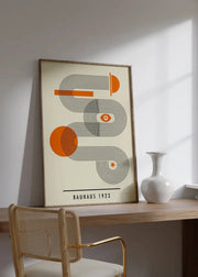 A framed decorbites™ mid century bauhaus canvas print featuring orange and black geometric wall art on cream background
