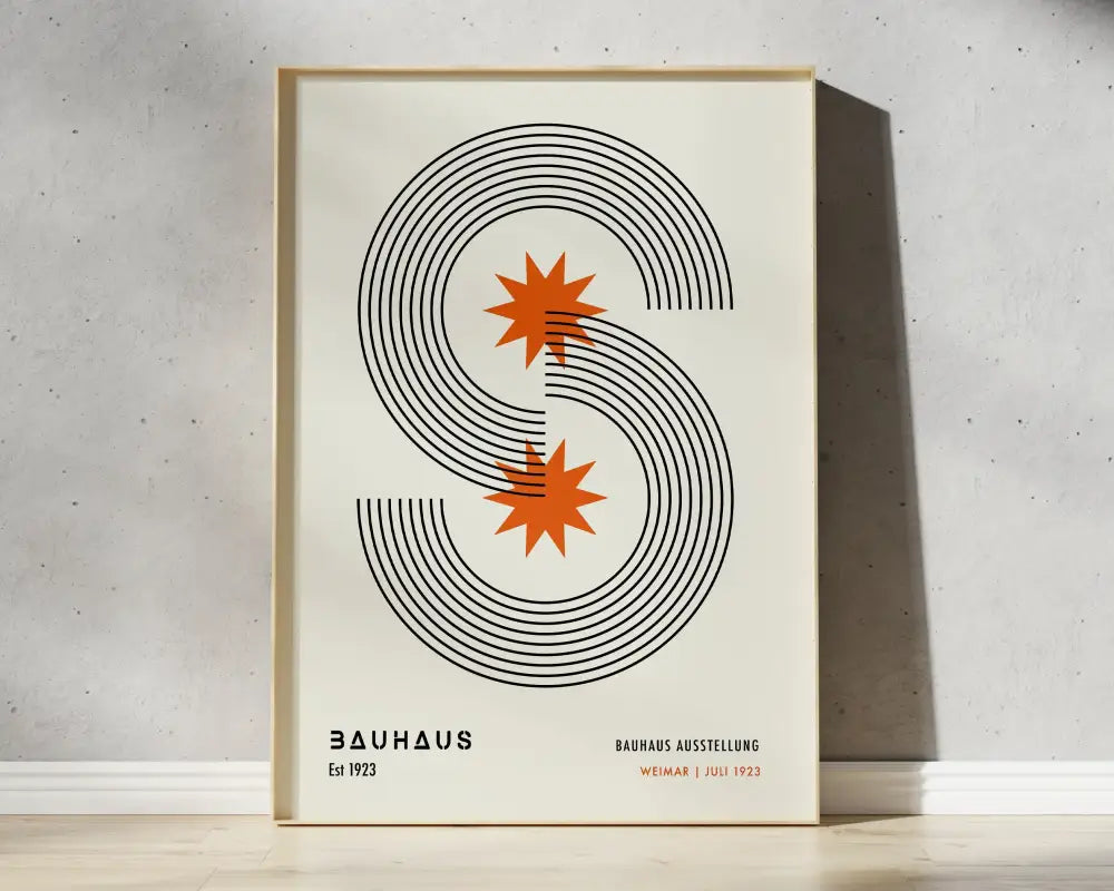 A minimalist framed canvas print featuring black geometric s and orange starbursts for mid century wall art home decor