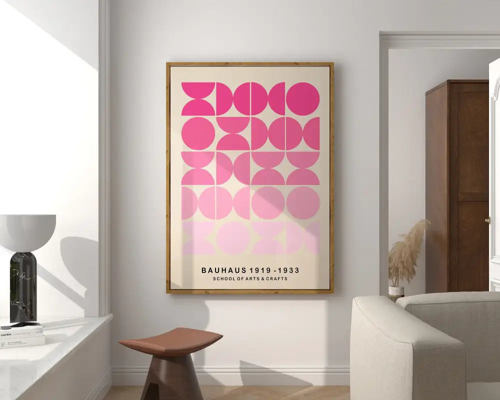 A framed bauhaus mid century canvas print with pink geometric mid century circles on an off-white background