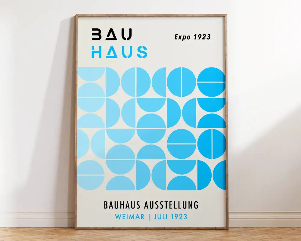 A framed decorbites™ geometric mid century canvas print featuring blue circles and bold black bau haus text on off-white background