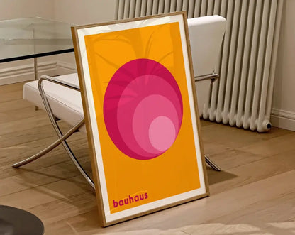 DecorBites™ geometric canvas poster featuring concentric pink circles on orange in a light wood frame wall art