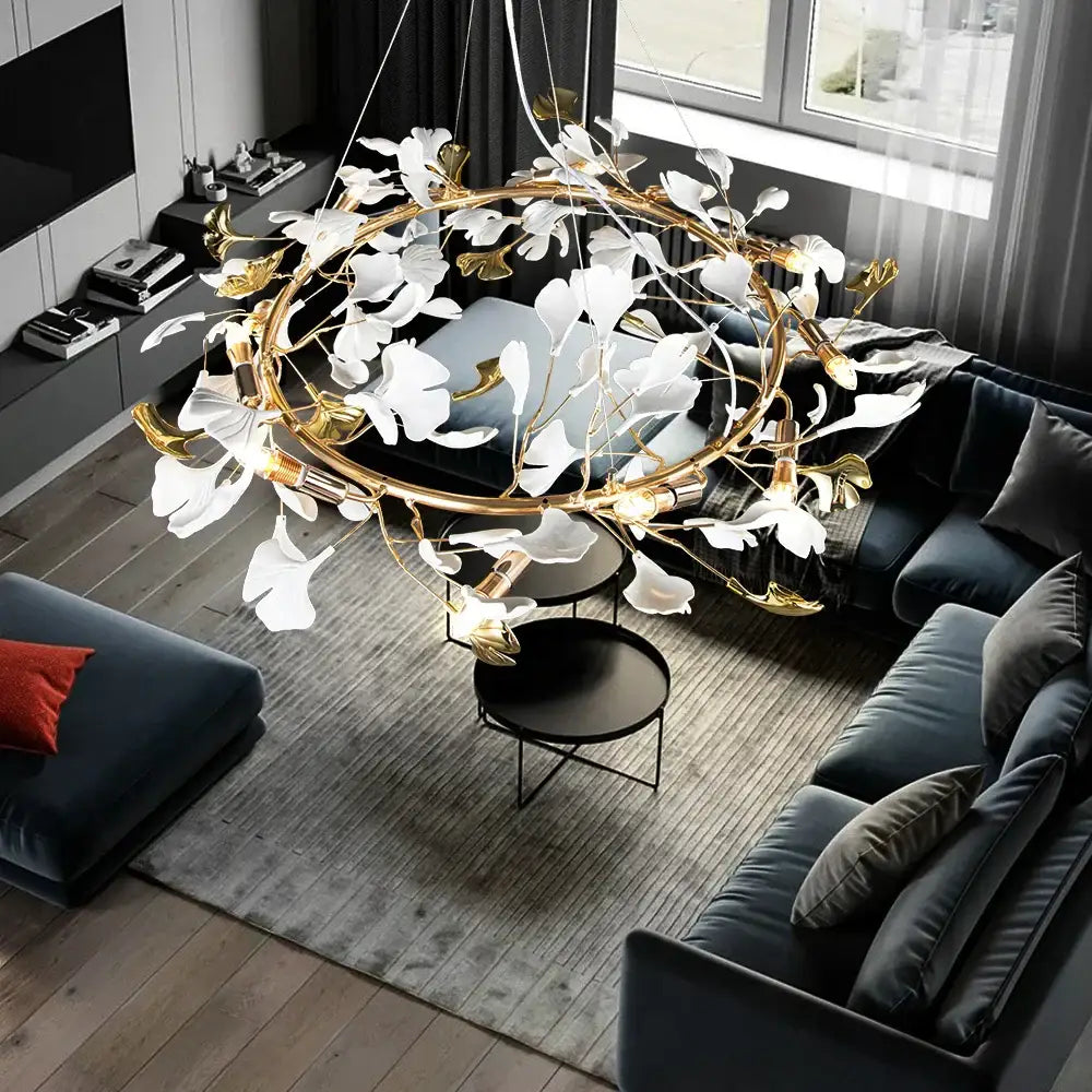 A decorbites ginkgo leaf crystal chandelier with a gold-toned metal frame and white petal-like floral elements