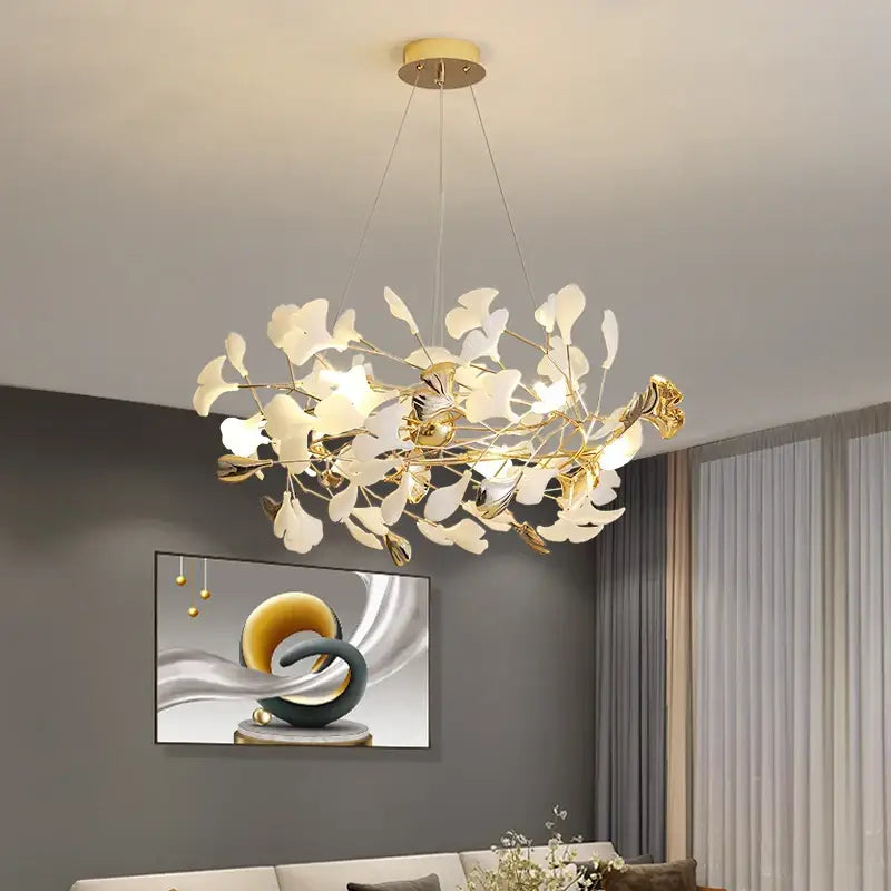 Gold-toned decorbites ginkgo leaf decor chandelier with delicate white glass leaves and modern branching design for living room