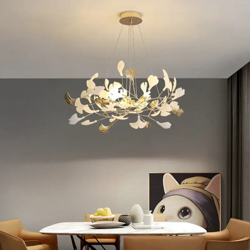 A modern gold-toned decorbites ginkgo leaf leaf decor chandelier with delicate white and metallic arms for living room