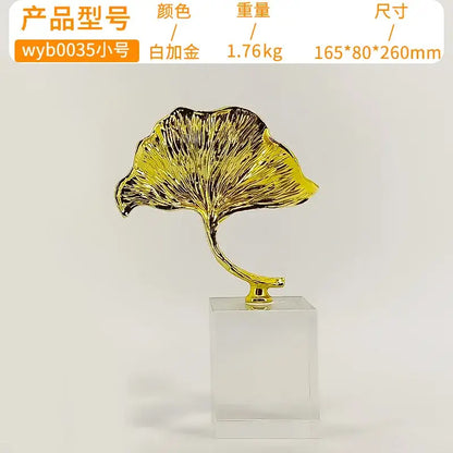 Decorbites ginkgo leaf metal sculpture in gold with intricate veins on clear acrylic base for home decor accent